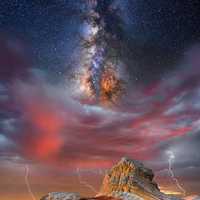 Galaxy and stars above the mountain with lightning 