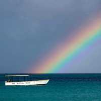 Rainbow over the ocean with a boat in Jamaica