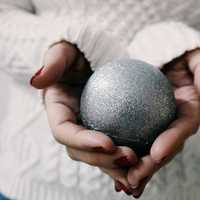 Hands holding a Christmas Ornament Ball 