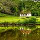 House by the pond in greenery