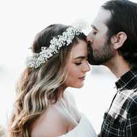 man-kissing-girl-with-flower-crown