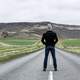 man-standing-in-the-middle-of-the-road-in-iceland