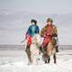 mongolian-couple-on-horseback-in-the-winter