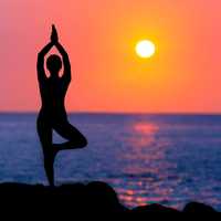 woman-doing-yoga-at-sunset