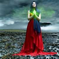 woman-illuminated-with-green-light-under-stormy-cloudds
