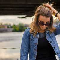 woman-in-sunglasses-and-blue-jeans-shirt