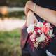 woman-with-arms-wrapped-around-a-man-with-bouquet-flowers