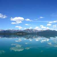 Reflections of mountains and clouds on Lake Clark
