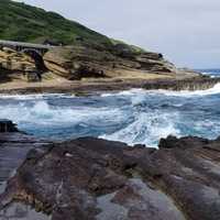 Large Waves crashing on rocks with shoreline landscape
