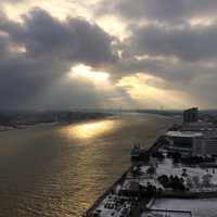Sun shining through the clouds on the river in Detroit, Michigan