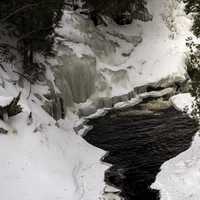 Small Pool beneath a waterfall in the winter as Cascade River State Park, Minnesota